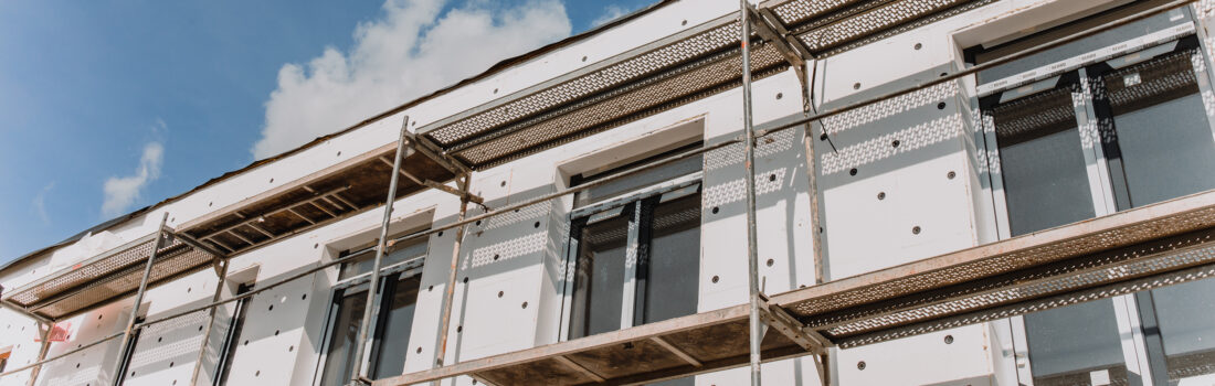 Gerüst an einer Hausfassade, modernes Gebäude im Bau –